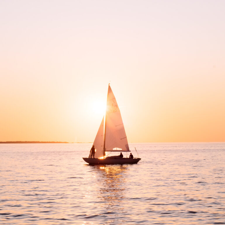 Boat sailing during sunset over baltic sea while sunset
