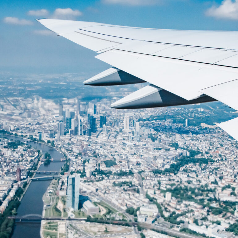 Travel with Lufthansa - Airplane view over city skyline